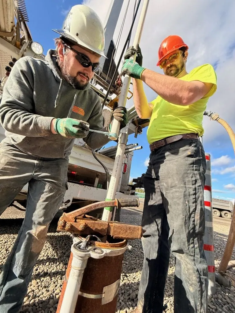 Arcadia technicians setting pipe on a well